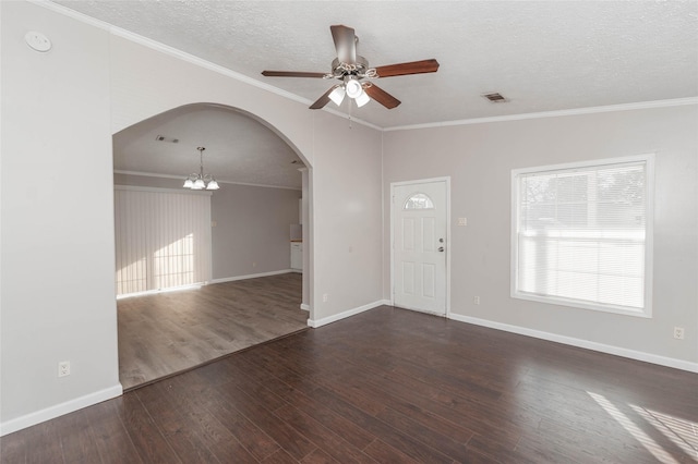 interior space featuring arched walkways, dark wood-style floors, ornamental molding, a textured ceiling, and ceiling fan with notable chandelier