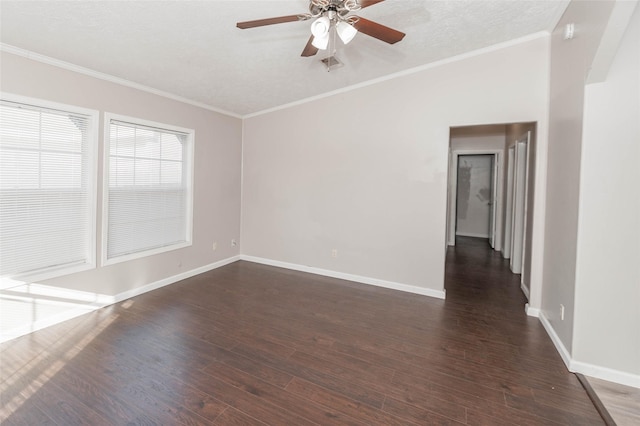 empty room with dark wood-style floors, visible vents, and crown molding