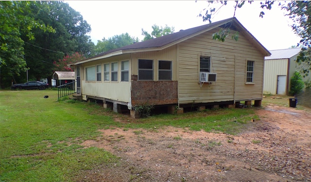 view of home's exterior featuring a lawn and cooling unit