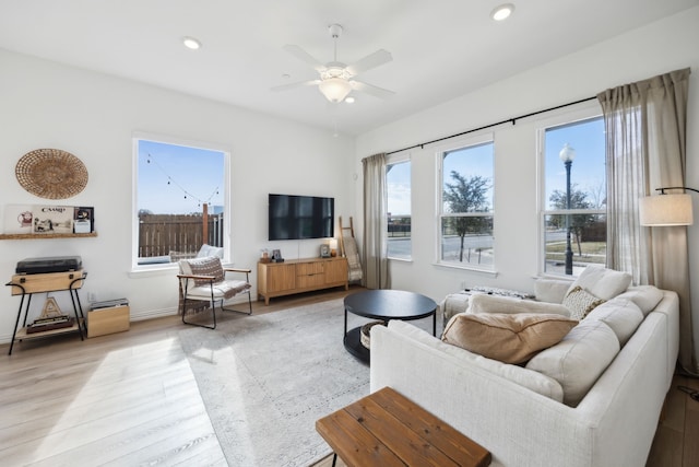 living area with ceiling fan, baseboards, light wood-style flooring, and recessed lighting