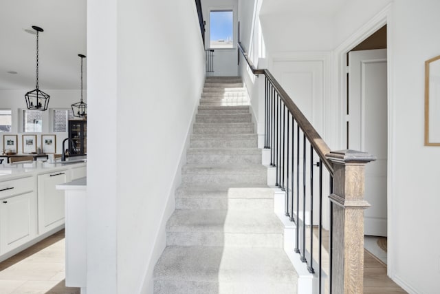 stairs with wood finished floors and baseboards