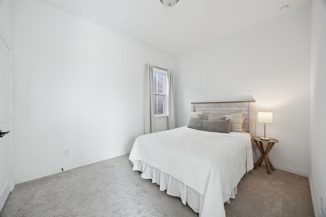 bedroom featuring carpet and baseboards