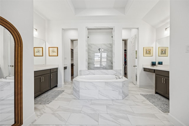 full bath featuring a walk in closet, marble finish floor, a garden tub, and vanity