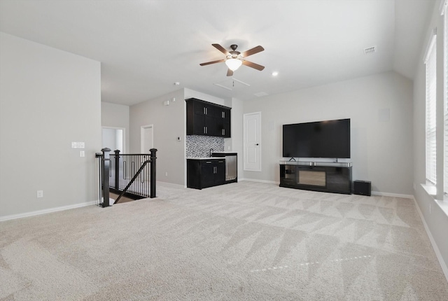 unfurnished living room featuring light carpet, baseboards, visible vents, and ceiling fan