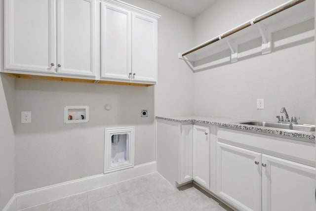 clothes washing area with gas dryer hookup, washer hookup, a sink, cabinet space, and electric dryer hookup