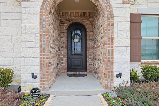 entrance to property with brick siding