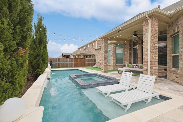 view of pool with a patio, ceiling fan, fence, a pool with connected hot tub, and outdoor lounge area