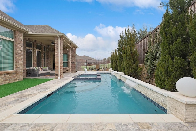 view of pool with a patio, a fenced backyard, and a pool with connected hot tub