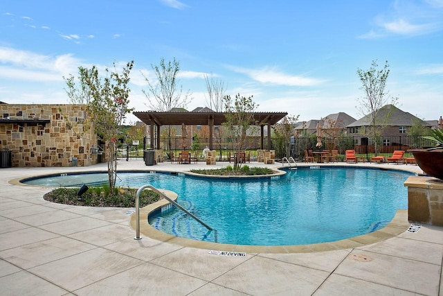 community pool with a patio area and fence