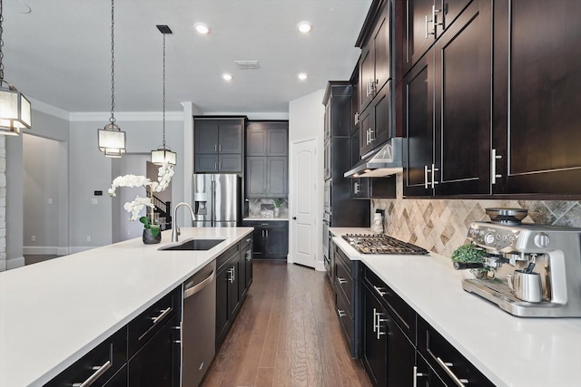 kitchen with stainless steel appliances, visible vents, light countertops, a sink, and under cabinet range hood