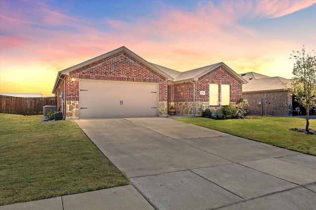 single story home with concrete driveway, brick siding, and a front lawn