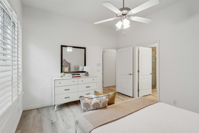 bedroom with a ceiling fan and light wood-type flooring