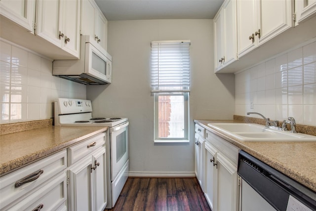 4039 Cole Ave Unit 104, Dallas, TX 75204 - kitchen featuring white appliances, a sink, backsplash, white cabinets, and dark wood-type flooring
