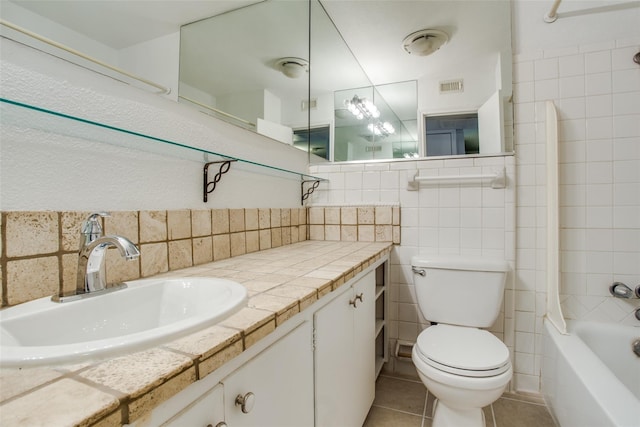 4039 Cole Ave Unit 104, Dallas, TX 75204 - bathroom with vanity, toilet, tile patterned floors, tile walls, and shower / bath combination