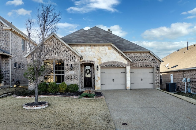 french provincial home featuring brick siding, a shingled roof, concrete driveway, an attached garage, and a front yard