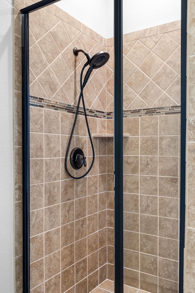 interior details featuring a stall shower