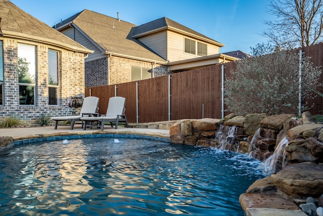 view of swimming pool featuring a fenced in pool, a patio area, and fence