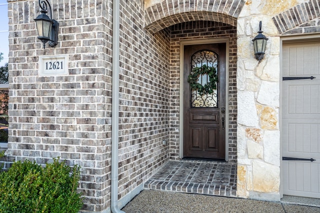 doorway to property with brick siding