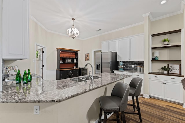 kitchen featuring a sink, visible vents, white cabinets, and stainless steel fridge with ice dispenser