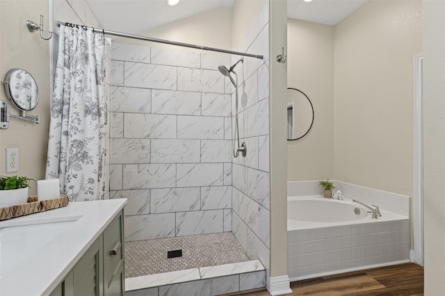 full bath featuring a bath, tiled shower, vanity, and wood finished floors