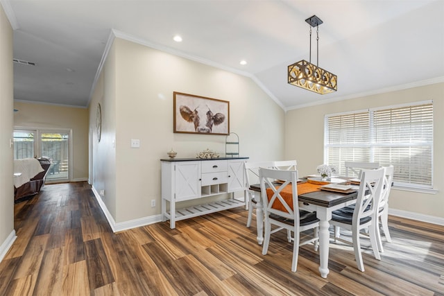 dining space with crown molding, baseboards, and wood finished floors