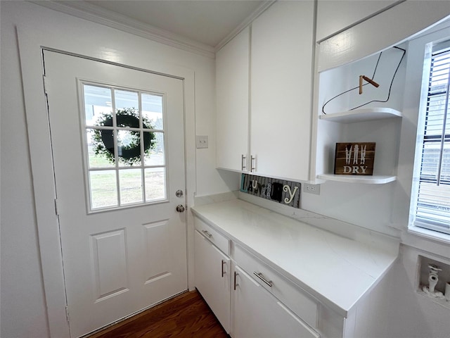 doorway featuring dark wood finished floors and crown molding