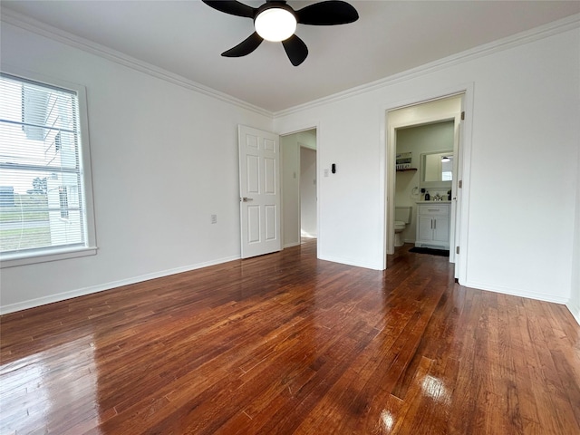 unfurnished bedroom featuring baseboards, connected bathroom, ceiling fan, ornamental molding, and dark wood-type flooring