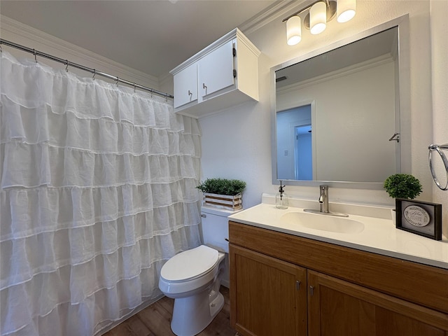 full bathroom featuring crown molding, curtained shower, toilet, vanity, and wood finished floors