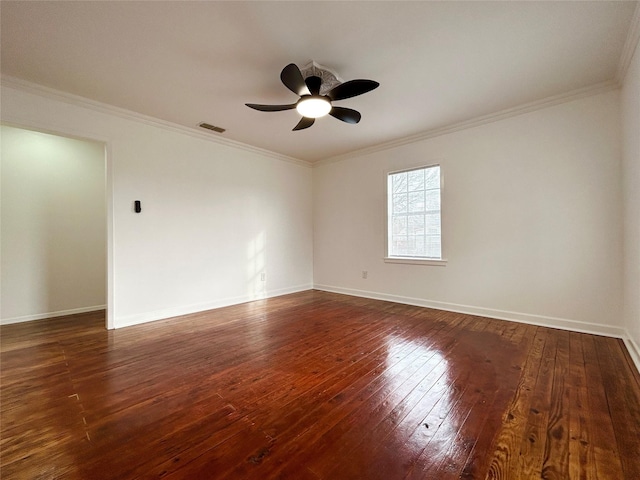 spare room with baseboards, visible vents, dark wood-type flooring, and ornamental molding