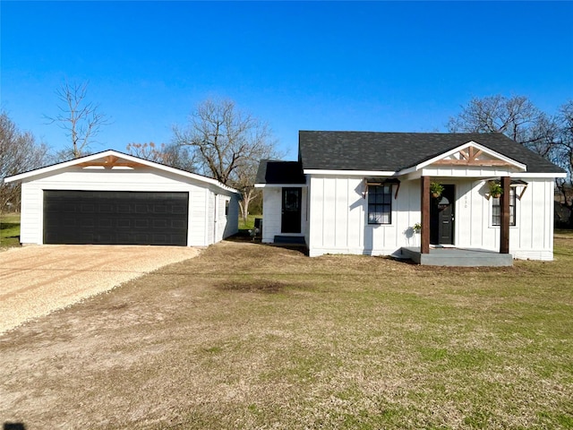 modern inspired farmhouse with a garage, a front lawn, board and batten siding, and a shingled roof