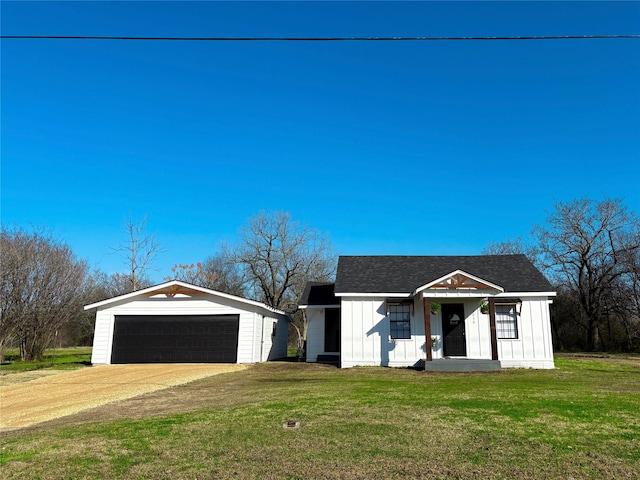 modern farmhouse style home with a garage, a front lawn, and board and batten siding