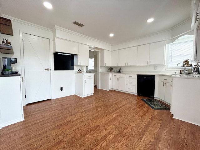 kitchen featuring dark wood-style floors, black dishwasher, light countertops, and white cabinets