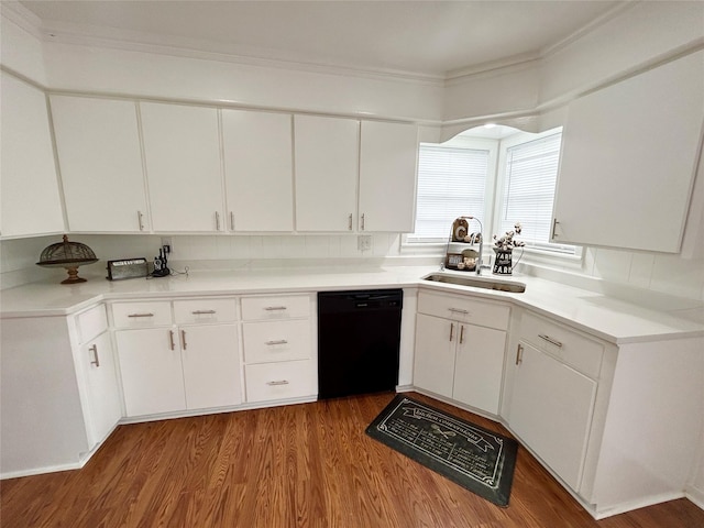 kitchen featuring black dishwasher, light countertops, and white cabinets