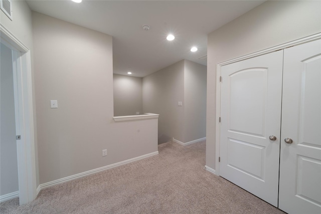 interior space with light carpet, baseboards, visible vents, and recessed lighting