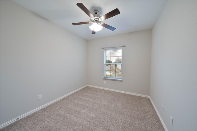 unfurnished room featuring ceiling fan, light colored carpet, and baseboards