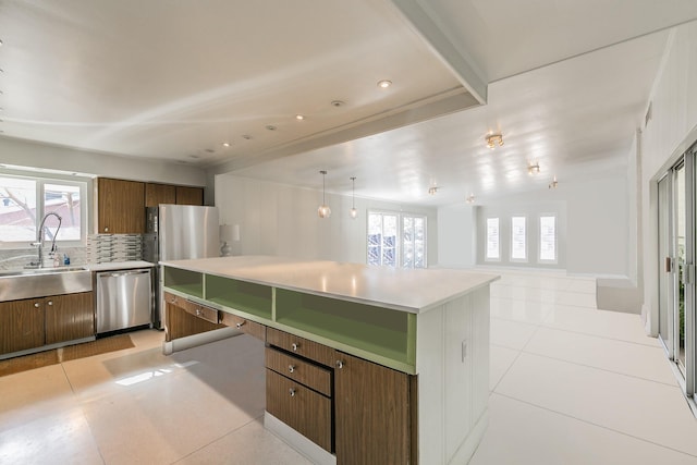 kitchen featuring appliances with stainless steel finishes, a sink, plenty of natural light, light countertops, and recessed lighting