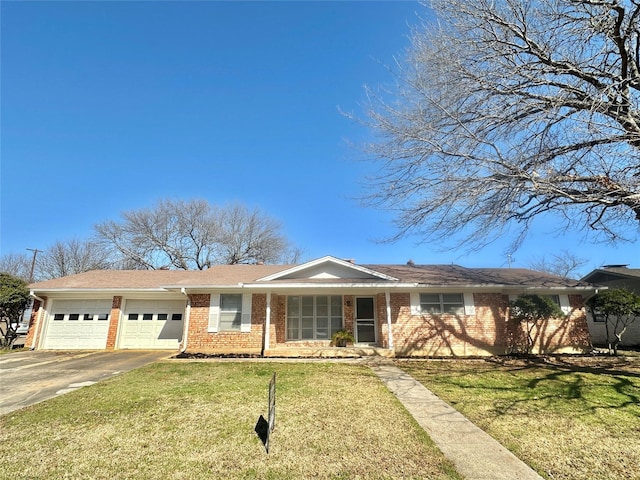 ranch-style house featuring driveway, a front lawn, an attached garage, and brick siding