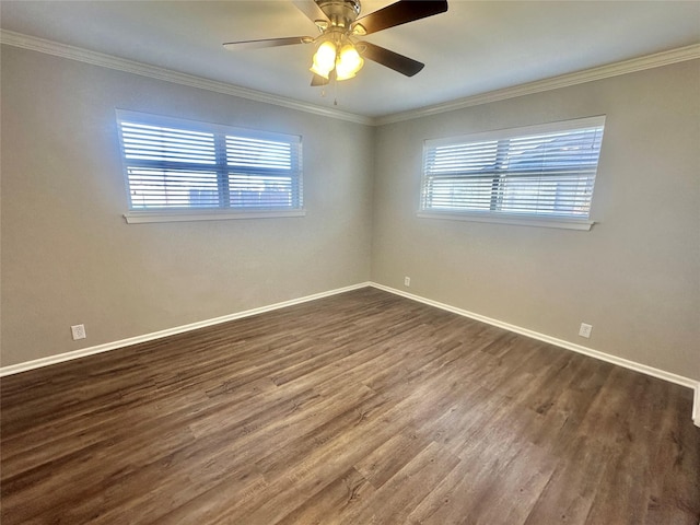 spare room with dark wood-style floors, baseboards, and crown molding