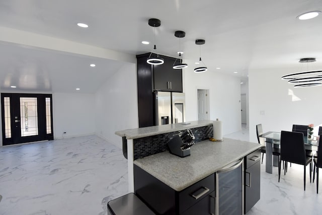 556 Fm 1999, Karnack, TX 75661 - kitchen with pendant lighting, wine cooler, stainless steel refrigerator with ice dispenser, and a center island