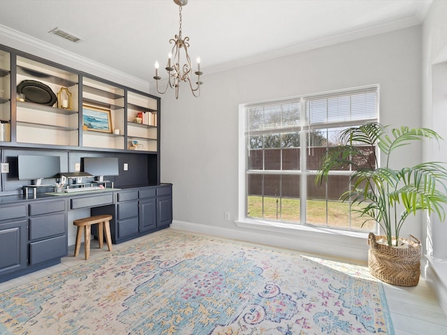 home office with visible vents, crown molding, baseboards, a notable chandelier, and built in study area