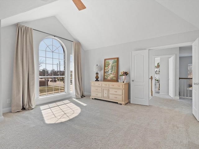 unfurnished bedroom with a ceiling fan, lofted ceiling, and carpet