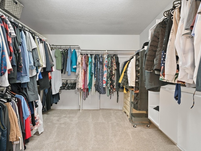 walk in closet with carpet floors