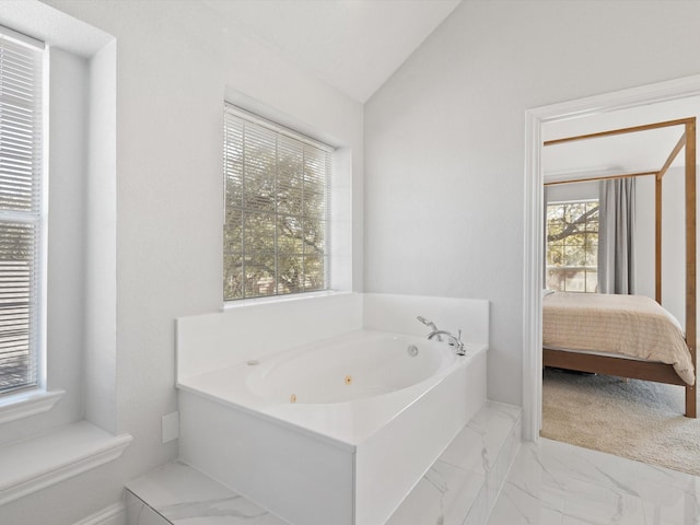 full bathroom featuring marble finish floor, ensuite bath, a whirlpool tub, and vaulted ceiling