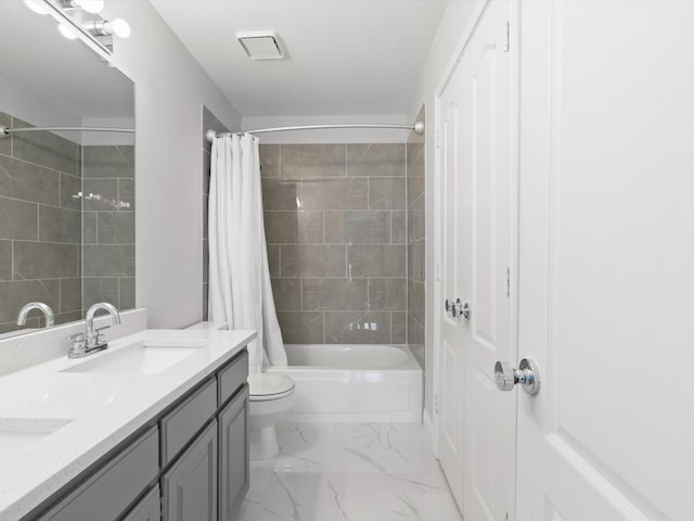 full bathroom featuring double vanity, a sink, shower / bath combination with curtain, toilet, and marble finish floor