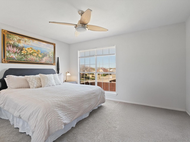 carpeted bedroom with a ceiling fan and baseboards