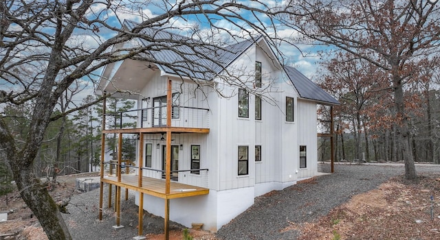 view of home's exterior featuring metal roof and a balcony