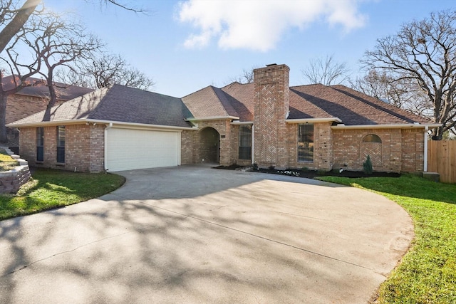 view of front of property featuring an attached garage, brick siding, fence, concrete driveway, and a chimney