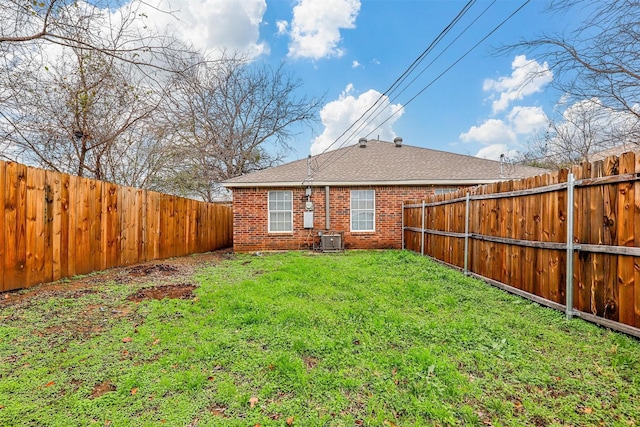 exterior space with central AC and a fenced backyard