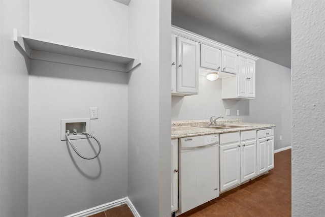 kitchen featuring light countertops, white cabinets, dishwasher, and a sink