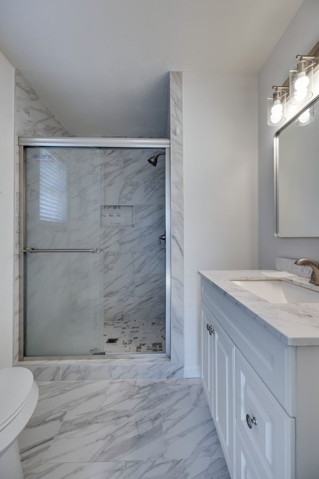 bathroom with a stall shower, vanity, toilet, and marble finish floor